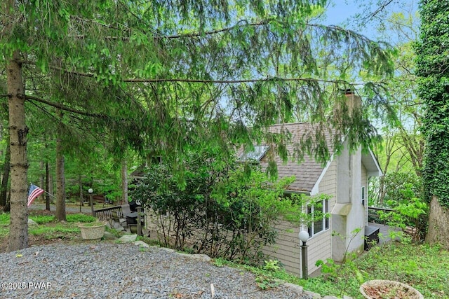 88 Paupack Point Rd, Hawley, PA 18428 - view of home's exterior with a chimney and a shingled roof