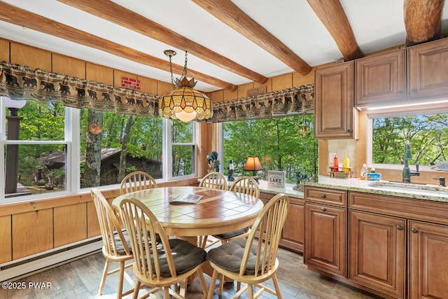 88 Paupack Point Rd, Hawley, PA 18428 - dining space with beamed ceiling, light wood-style flooring, healthy amount of natural light, and baseboard heating