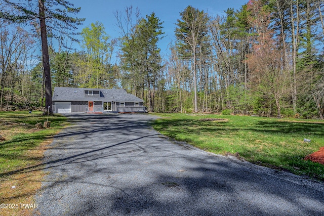133 Neil Thompson Rd, Lackawaxen, PA 18435 - ranch-style home with covered porch, asphalt driveway, a front yard, and a wooded view