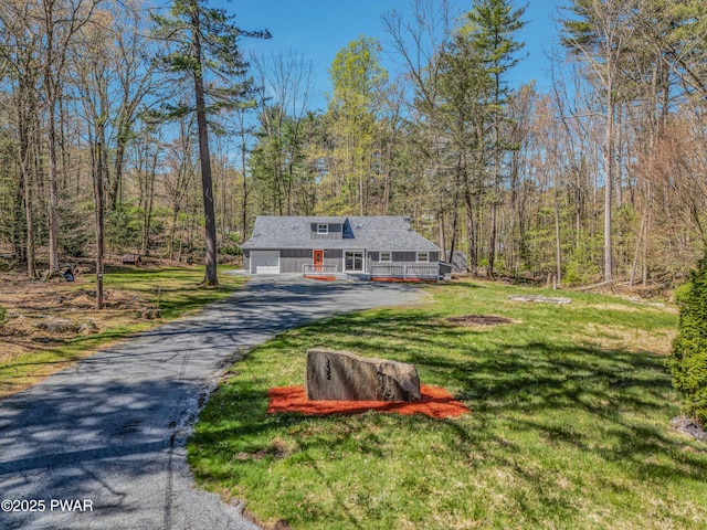 133 Neil Thompson Rd, Lackawaxen, PA 18435 - view of front of home with a front lawn, driveway, a wooded view, a porch, and an attached garage