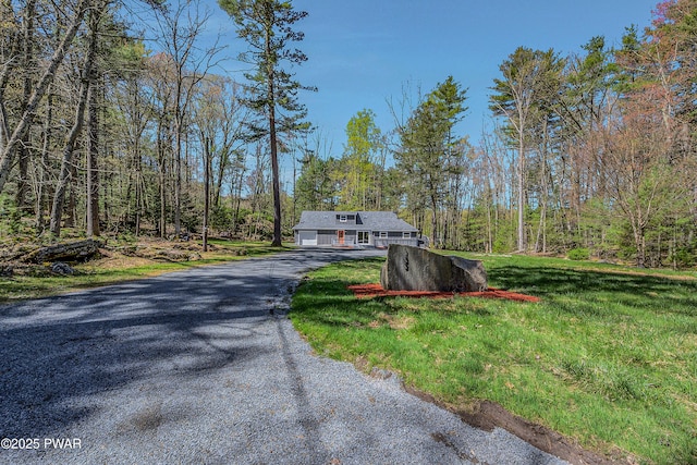 133 Neil Thompson Rd, Lackawaxen, PA 18435 - view of front of house featuring driveway, a garage, a front lawn, and a wooded view