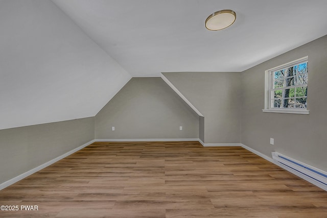 133 Neil Thompson Rd, Lackawaxen, PA 18435 - additional living space with baseboard heating, wood finished floors, and vaulted ceiling