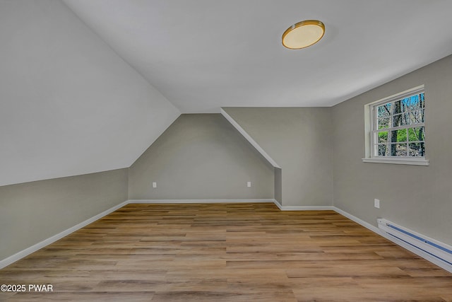 133 Neil Thompson Rd, Lackawaxen, PA 18435 - additional living space featuring a baseboard heating unit, wood finished floors, and lofted ceiling