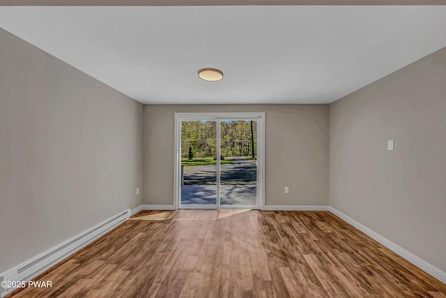133 Neil Thompson Rd, Lackawaxen, PA 18435 - unfurnished room with a baseboard heating unit and wood finished floors