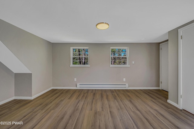 133 Neil Thompson Rd, Lackawaxen, PA 18435 - below grade area featuring a baseboard heating unit and wood finished floors