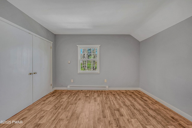 133 Neil Thompson Rd, Lackawaxen, PA 18435 - unfurnished bedroom featuring baseboard heating, light wood-style flooring, a closet, and lofted ceiling