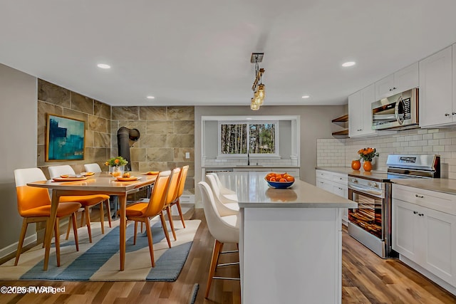 133 Neil Thompson Rd, Lackawaxen, PA 18435 - kitchen featuring appliances with stainless steel finishes, light countertops, white cabinets, a center island, and recessed lighting