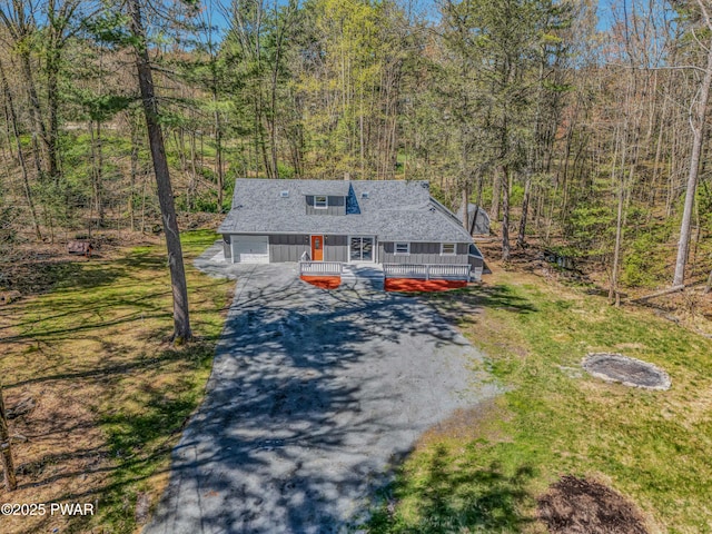 133 Neil Thompson Rd, Lackawaxen, PA 18435 - rustic home featuring asphalt driveway, a garage, roof with shingles, a wooden deck, and a view of trees