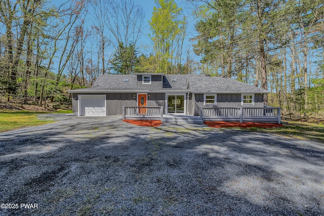 133 Neil Thompson Rd, Lackawaxen, PA 18435 - view of front of house with board and batten siding, a garage, gravel driveway, and a shingled roof
