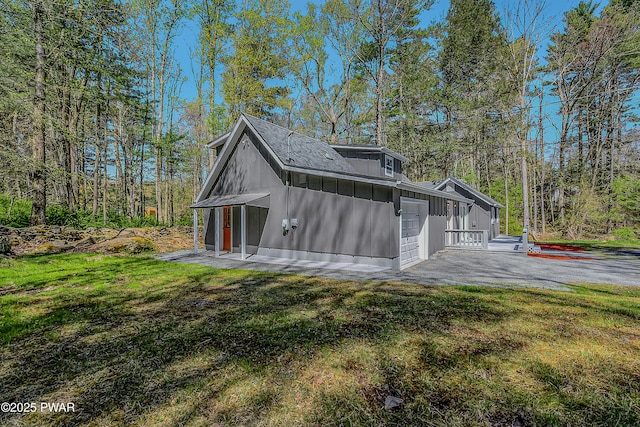 133 Neil Thompson Rd, Lackawaxen, PA 18435 - view of property exterior featuring board and batten siding, a yard, and driveway