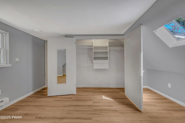 133 Neil Thompson Rd, Lackawaxen, PA 18435 - unfurnished bedroom with a skylight, light wood finished floors, a closet, and multiple windows