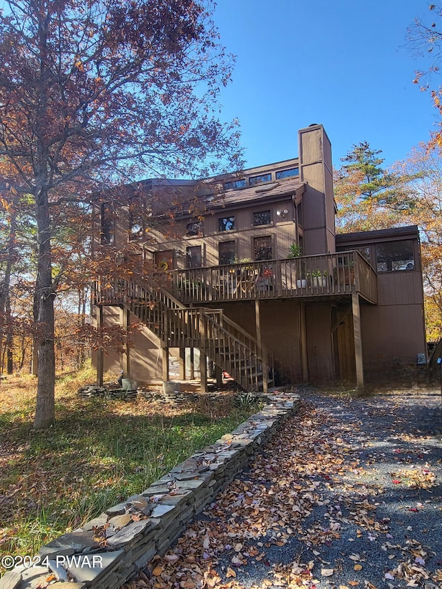 rear view of house featuring a deck