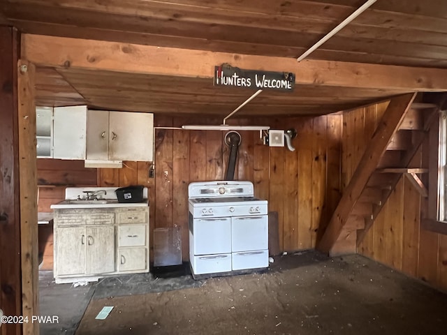 kitchen featuring wood walls and white stove