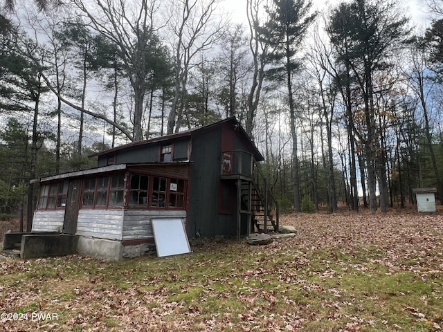 view of property exterior with a sunroom