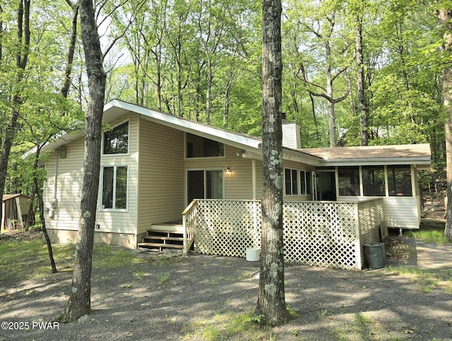 113 Widgeon Ln, Lords Valley, PA 18428 - back of house featuring a chimney, a sunroom, and a deck