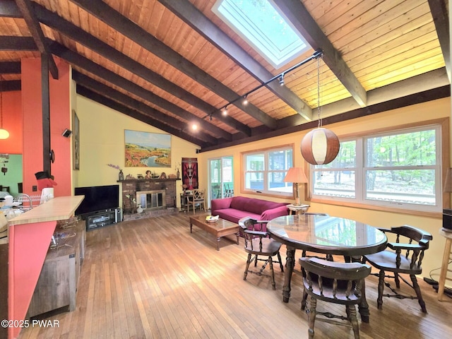 113 Widgeon Ln, Lords Valley, PA 18428 - dining area featuring a skylight, wood ceiling, hardwood / wood-style floors, and a fireplace