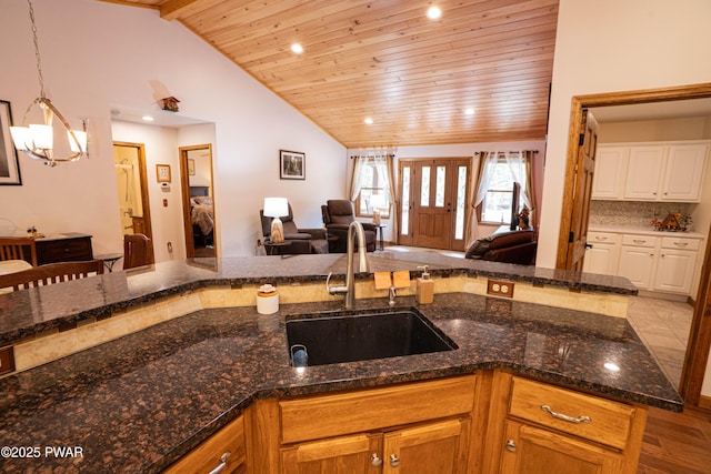 1010 Lotus Ter, Lake Ariel, PA 18436 - kitchen featuring open floor plan, wooden ceiling, a chandelier, dark stone countertops, and lofted ceiling
