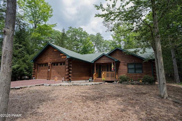 1010 Lotus Ter, Lake Ariel, PA 18436 - cabin with an attached garage, log exterior, covered porch, and driveway