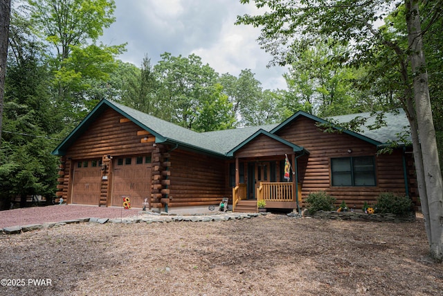 1010 Lotus Ter, Lake Ariel, PA 18436 - log cabin with covered porch, log exterior, an attached garage, a shingled roof, and driveway