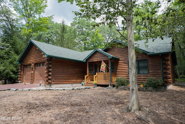 1010 Lotus Ter, Lake Ariel, PA 18436 - log cabin featuring log siding, a garage, roof with shingles, and a porch