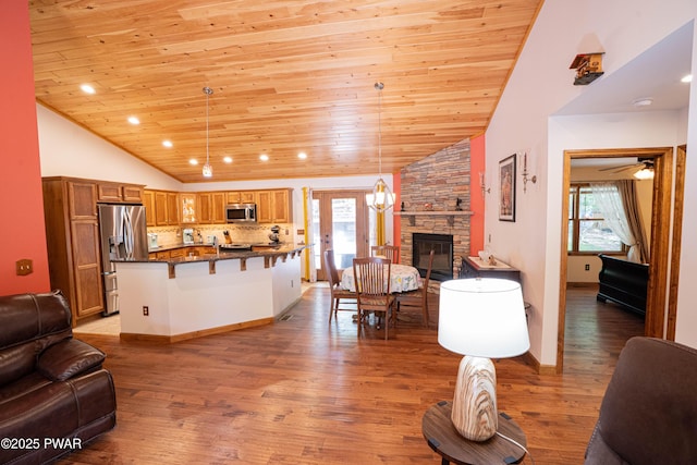 1010 Lotus Ter, Lake Ariel, PA 18436 - living room featuring lofted ceiling, wooden ceiling, a fireplace, and light wood finished floors