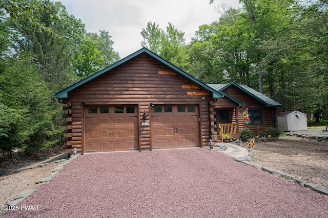 1010 Lotus Ter, Lake Ariel, PA 18436 - log cabin with log exterior, a storage unit, gravel driveway, and a garage