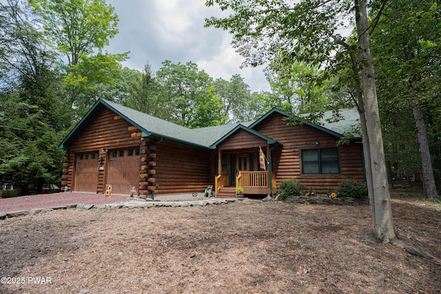 1010 Lotus Ter, Lake Ariel, PA 18436 - log home featuring an attached garage, log siding, a porch, and driveway