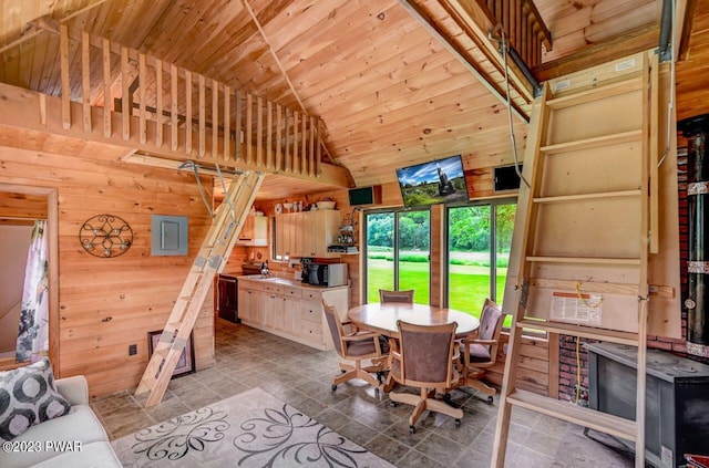 tiled dining space featuring wood walls, high vaulted ceiling, and wooden ceiling