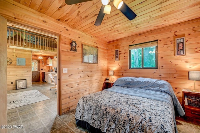 tiled bedroom with ceiling fan, wood ceiling, and wooden walls