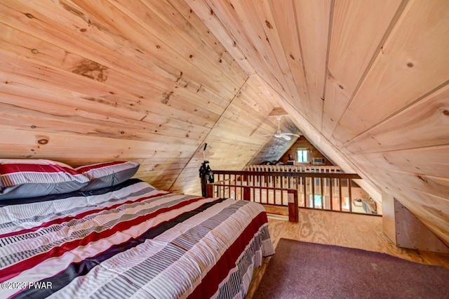 bedroom with wooden walls, lofted ceiling, hardwood / wood-style flooring, and wooden ceiling