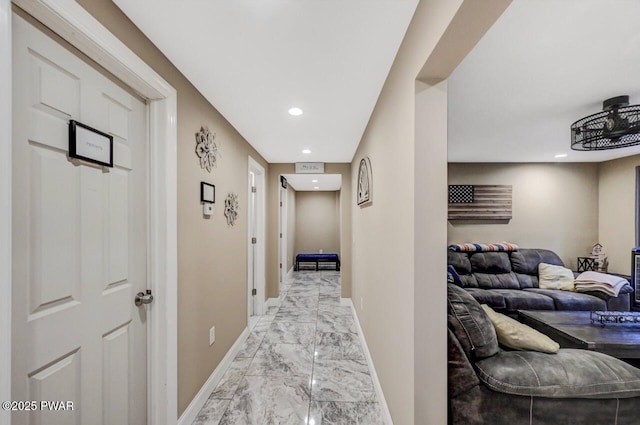 corridor with recessed lighting, baseboards, and marble finish floor
