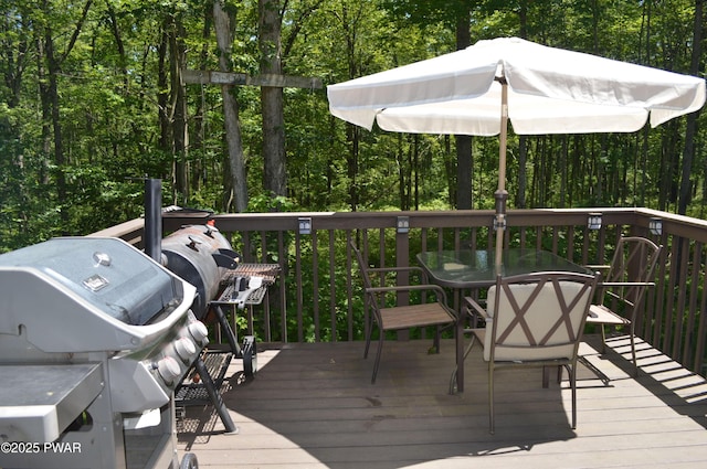 292 Well Rd, Greeley, PA 18425 - wooden terrace featuring outdoor dining space, a forest view, and grilling area