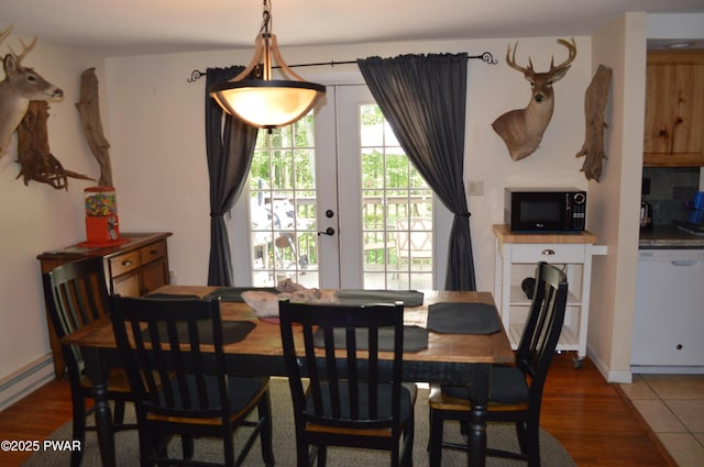 292 Well Rd, Greeley, PA 18425 - dining area with wood finished floors, french doors, and a baseboard radiator