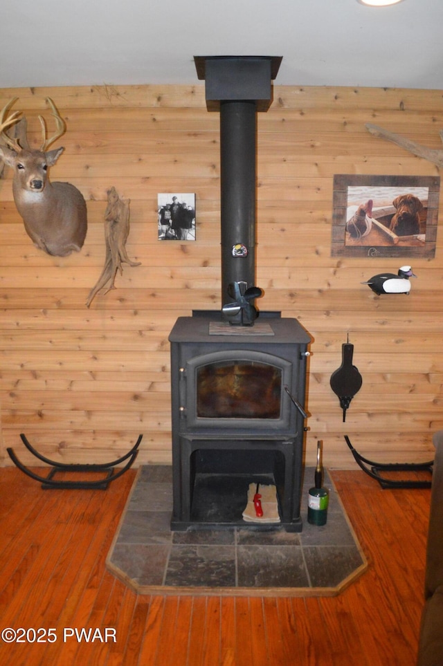 292 Well Rd, Greeley, PA 18425 - detailed view of a wood stove, wooden walls, and wood finished floors