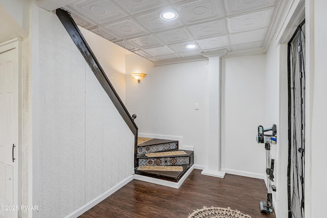 interior space with baseboards, an ornate ceiling, recessed lighting, and wood finished floors