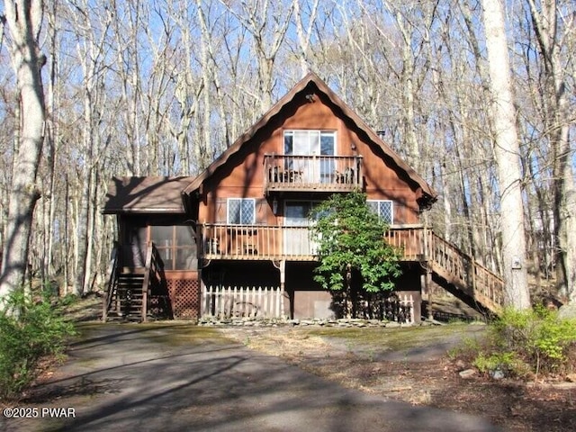 chalet / cabin with a wooden deck and stairway