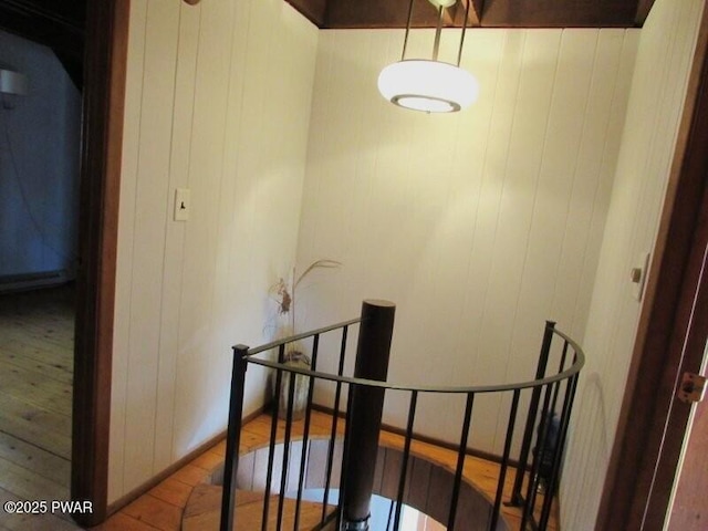 interior space with wood finished floors and wooden walls