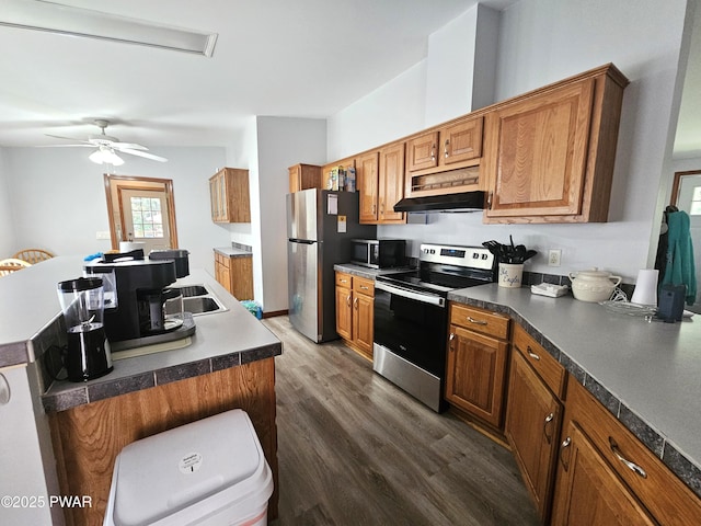 115 Deer Path, Tafton, PA 18464 - kitchen featuring appliances with stainless steel finishes, dark wood-style floors, a kitchen island with sink, brown cabinetry, and under cabinet range hood