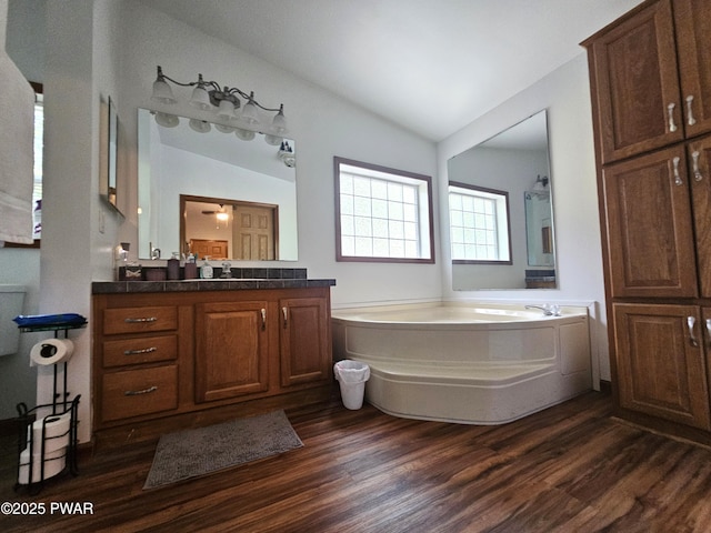 115 Deer Path, Tafton, PA 18464 - bathroom featuring vaulted ceiling, wood finished floors, a bath, and vanity