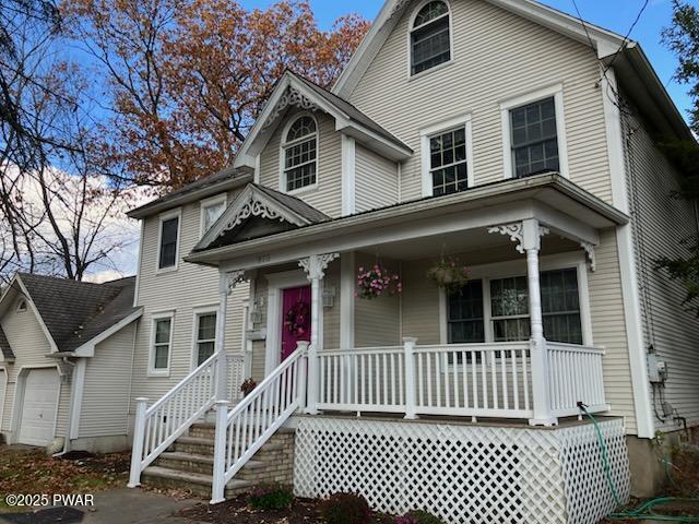 view of front of home featuring covered porch and a garage