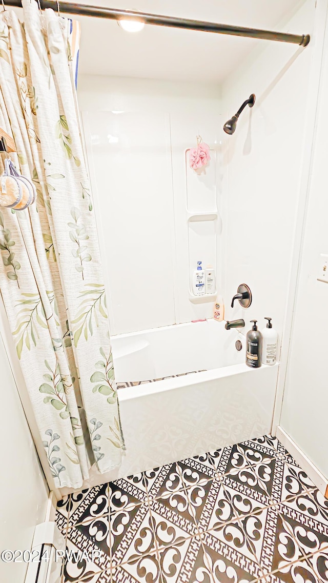 bathroom featuring tile patterned floors and shower / bath combo with shower curtain