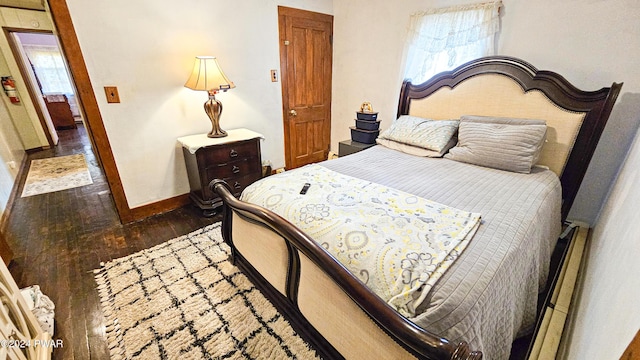 bedroom with dark wood-type flooring