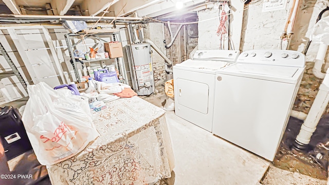 laundry area with water heater and washer and dryer