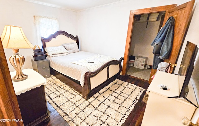 bedroom with dark hardwood / wood-style flooring, a closet, and crown molding