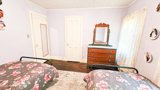 bedroom featuring crown molding and dark wood-type flooring