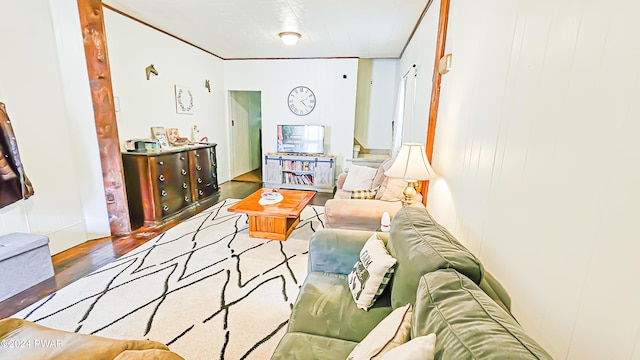 living room with hardwood / wood-style floors and ornamental molding