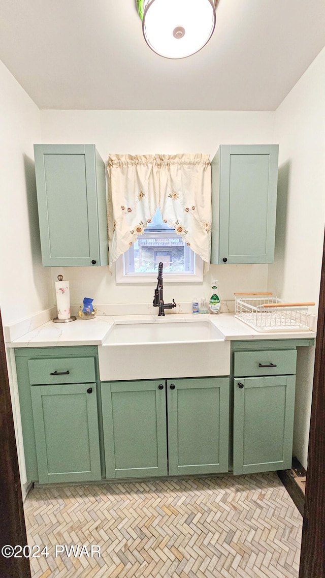 kitchen featuring sink and green cabinetry