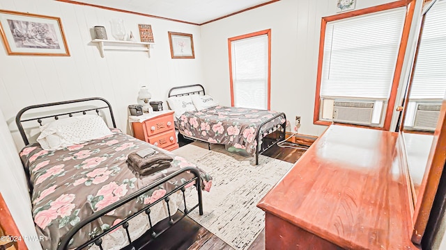 bedroom featuring hardwood / wood-style floors and crown molding