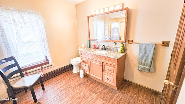 bathroom with hardwood / wood-style floors, vanity, and toilet