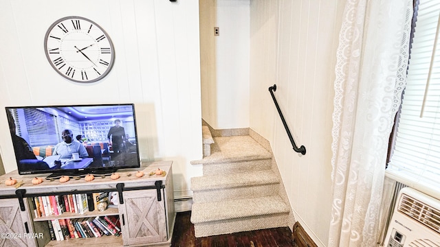 staircase with wood-type flooring and wooden walls